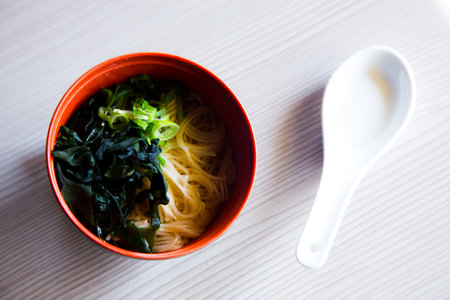 Miso soup is a Japanese soup made from a dashi brother and miso paste, which gives it its name. It can be served with tofu or noodles.の写真素材