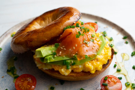 Toasted bagel with egg, avocado and smoked salmon. Very healthy breakfast or brunch.の写真素材
