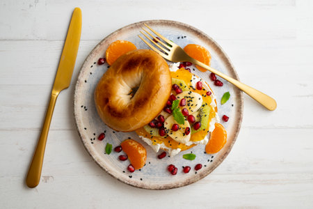 Toasted bagel with fruit such as mandarin, banana and jam. Very healthy breakfast or brunch.の写真素材