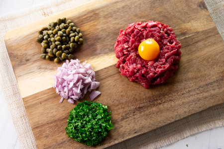 Beef steak tartare with egg and toast.の写真素材