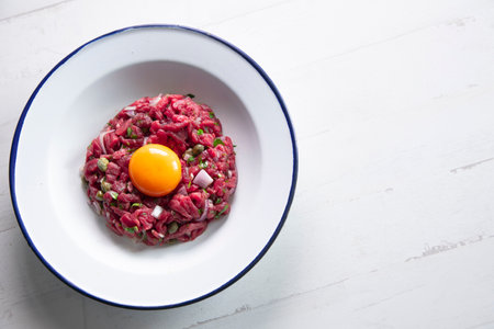Beef steak tartare with egg and toast.の写真素材