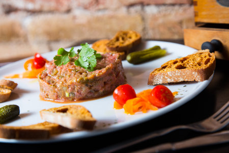 Beef steak tartare with egg and toast.の写真素材