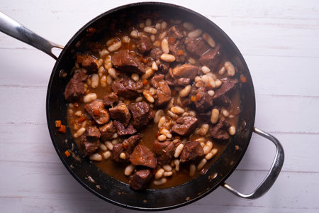 Braised beef with white beans. Traditional Spanish tapas recipe.の写真素材