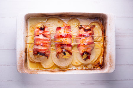 Spiced chicken rolled with bacon cooked in the oven.の写真素材