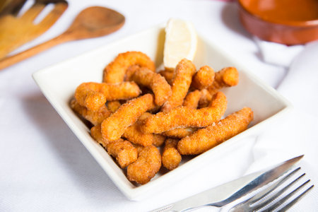 Battered chicken fingers in Spain.の写真素材