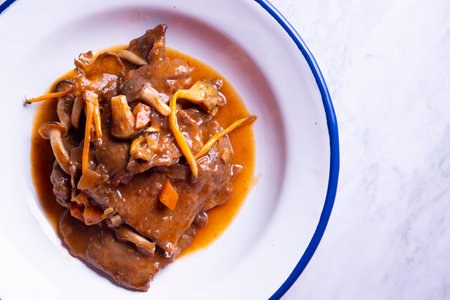 Fricando Veal cooked with sauce, vegetables and mushrooms. Typical Spanish tapas recipe.の写真素材