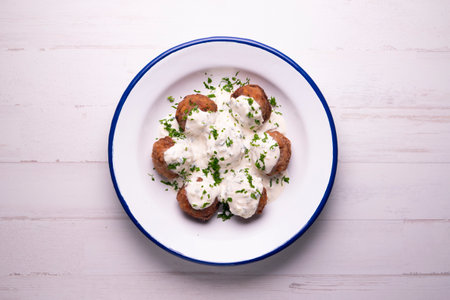 Greek style baked meatballs with tzatziki yogurt sauce.の写真素材