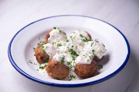 Greek style baked meatballs with tzatziki yogurt sauce.の写真素材