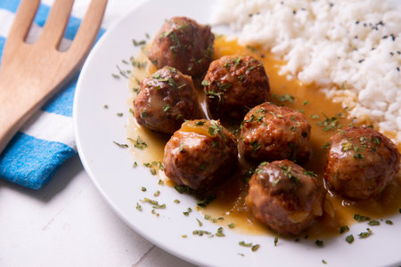Meatballs with tomato sauce and vegetables. Traditional Spanish cover.