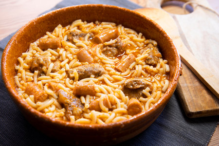 Fideua with pork. Casserole noodles with pork and sausages. Traditional Spanish cover.の写真素材