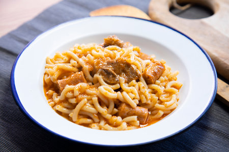 Fideua with pork. Casserole noodles with pork and sausages. Traditional Spanish cover.の写真素材