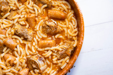 Fideua with pork. Casserole noodles with pork and sausages. Traditional Spanish cover.の写真素材