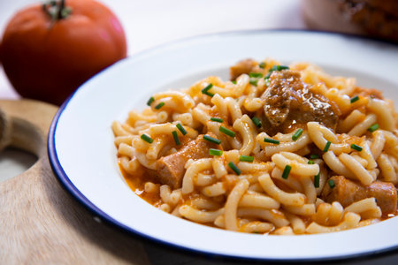Fideua with pork. Casserole noodles with pork and sausages. Traditional Spanish cover.の写真素材