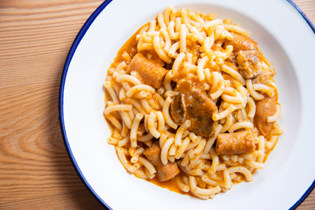 Fideua with pork. Casserole noodles with pork and sausages. Traditional Spanish cover.の写真素材