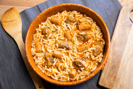 Fideua with pork. Casserole noodles with pork and sausages. Traditional Spanish cover.の写真素材