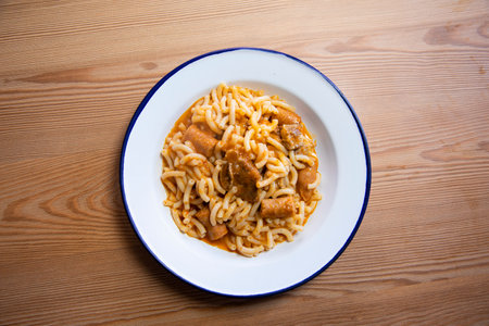 Fideua with pork. Casserole noodles with pork and sausages. Traditional Spanish cover.の写真素材
