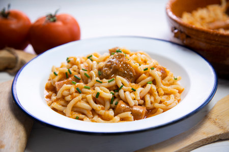 Fideua with pork. Casserole noodles with pork and sausages. Traditional Spanish cover.の写真素材