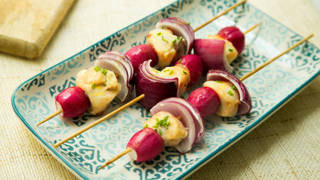 Roasted rabbit skewers with vegetables and cherry tomatoes.の写真素材