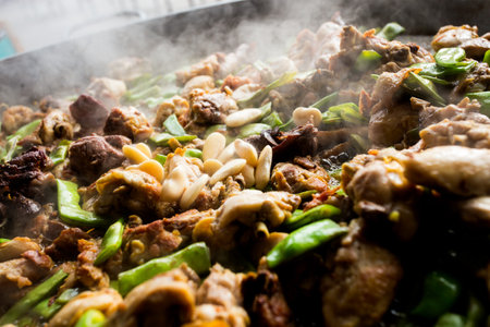 Cooking the authentic Valencian Spanish paella with chicken and rabbit.の写真素材
