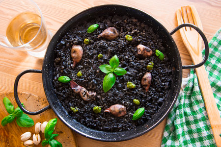 Black rice paella with seafood and fish. Traditional Spanish recipe.の写真素材