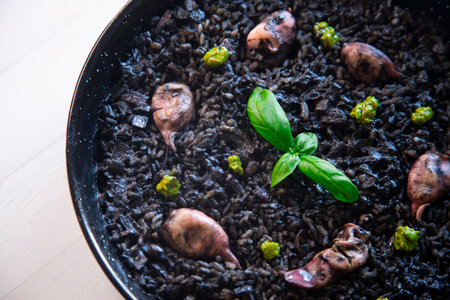 Black rice paella with seafood and fish. Traditional Spanish recipe.の写真素材