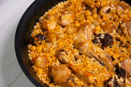 Rice paella with wild rabbit and vegetables.の写真素材