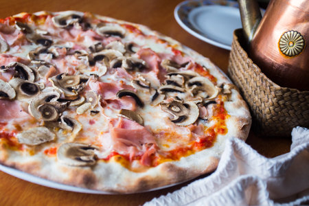 Mushroom Pizza. Neapolitan pizza with tomato sauce, cheese, ham and mushrooms. Authentic Italian recipe.の写真素材