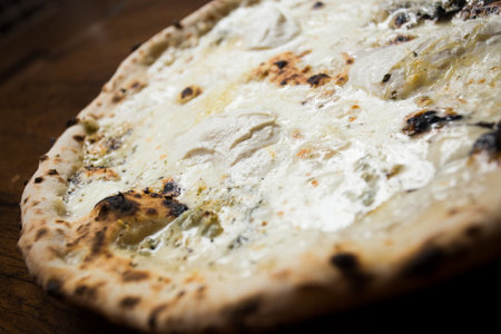 Four Cheese Pizza. Neapolitan pizza made with a variety of European cheeses such as Mozzarella, Brie and Gorgonzola. Italian vegetarian recipe.の写真素材