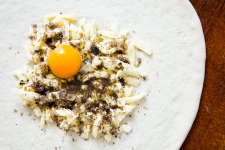 Pizza with truffle and egg. Neapolitan pizza made with cheese, black truffle and egg. Italian...