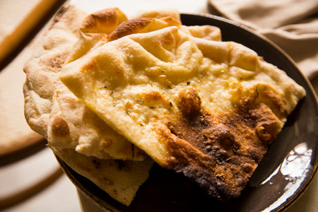 Focaccia is a kind of flat bread covered with herbs and other food products. It is a traditional Italian dish closely related to the popular pizza.の写真素材