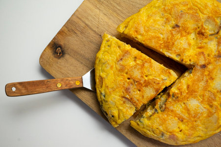Spanish potato omelette cut into the shape of a heart. Traditional tapa recipe with egg, potato, onion.の写真素材