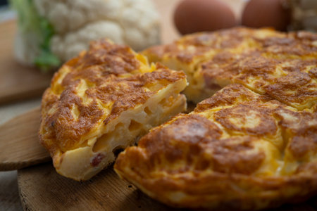 Spanish potato omelette with cauliflower. Traditional tapa recipe with egg, potato, onion.の写真素材