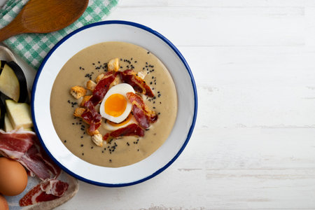 Roasted eggplant cream with ham and egg. Traditional Spanish tapas recipe.の写真素材