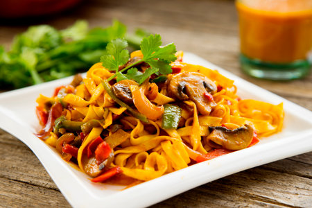 Noodles tomato sauce and baked vegetables.の写真素材