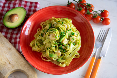 Noodles with avocado cream and prawns.の写真素材