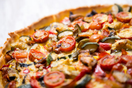 French quiche with pumpkin, cherry tomatoes, peppers and egg.の写真素材