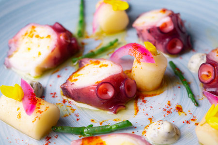 Braised octopus with potatoes and red onion.
