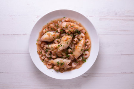Squid stewed with vegetables, prawns and potatoes. Traditional Spanish tapas recipe.の写真素材