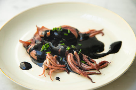 Baby squid in its black ink. Traditional Spanish tapas recipe.の写真素材