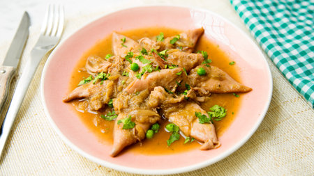 Baby Squid with onion sauce. Traditional Spanish tapa recipe.