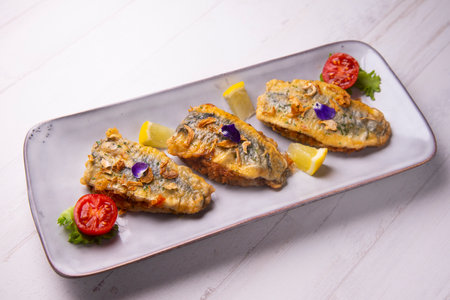 Fried stuffed anchovies from Malaga. Traditional Spanish tapa recipe.