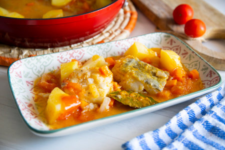 Stewed cod with potatoes and vegetables. Traditional northern Spanish recipe.の写真素材