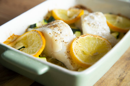 Cod loins cooked in the oven with zucchini herbs and lemon.の写真素材