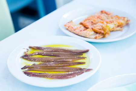 Cantabrian anchovies served with olive oil. Traditional northern Spanish tapa recipe.の写真素材