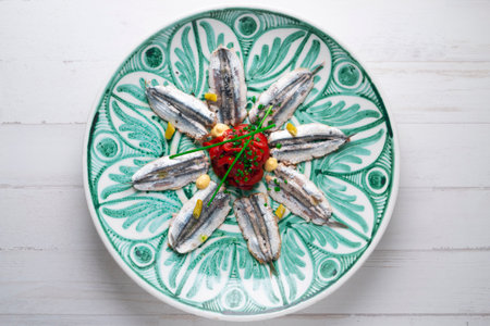 Anchovies marinated with a roasted red pepper and toast.の写真素材