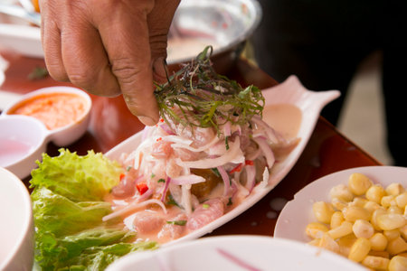 Preparing a delicious Peruvian sea bass ceviche in the fishing port of Chorios in Lima.の写真素材