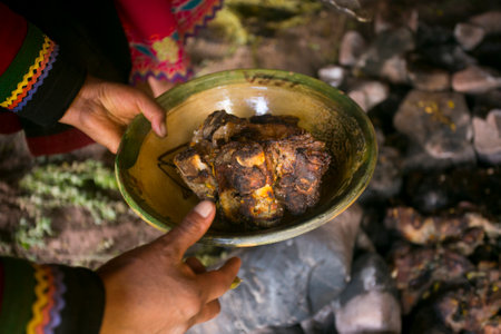 In the pachamanca ceremony, lamb, alpaca, pork and beef are cooked. Also variety of tubers and vegetables. All under hot stones and covered with earth.の写真素材