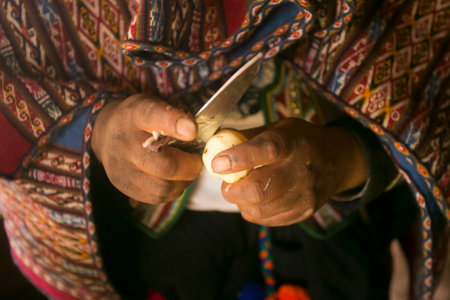 Cooking a traditional Andean vegetable soup before a Pachamanca feast with a Quechua tribe in the Sacred Valley, Peru.の写真素材