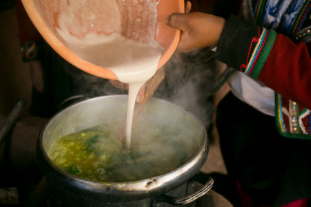 Cooking a traditional Andean vegetable soup before a Pachamanca feast with a Quechua tribe in the Sacred Valley, Peru.の写真素材