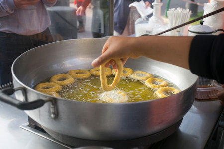 Picarones are ring-shaped fried sweets made with wheat flour dough mixed with squash, and sometimes...